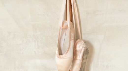 ballet pointe shoes hung up on a hanger